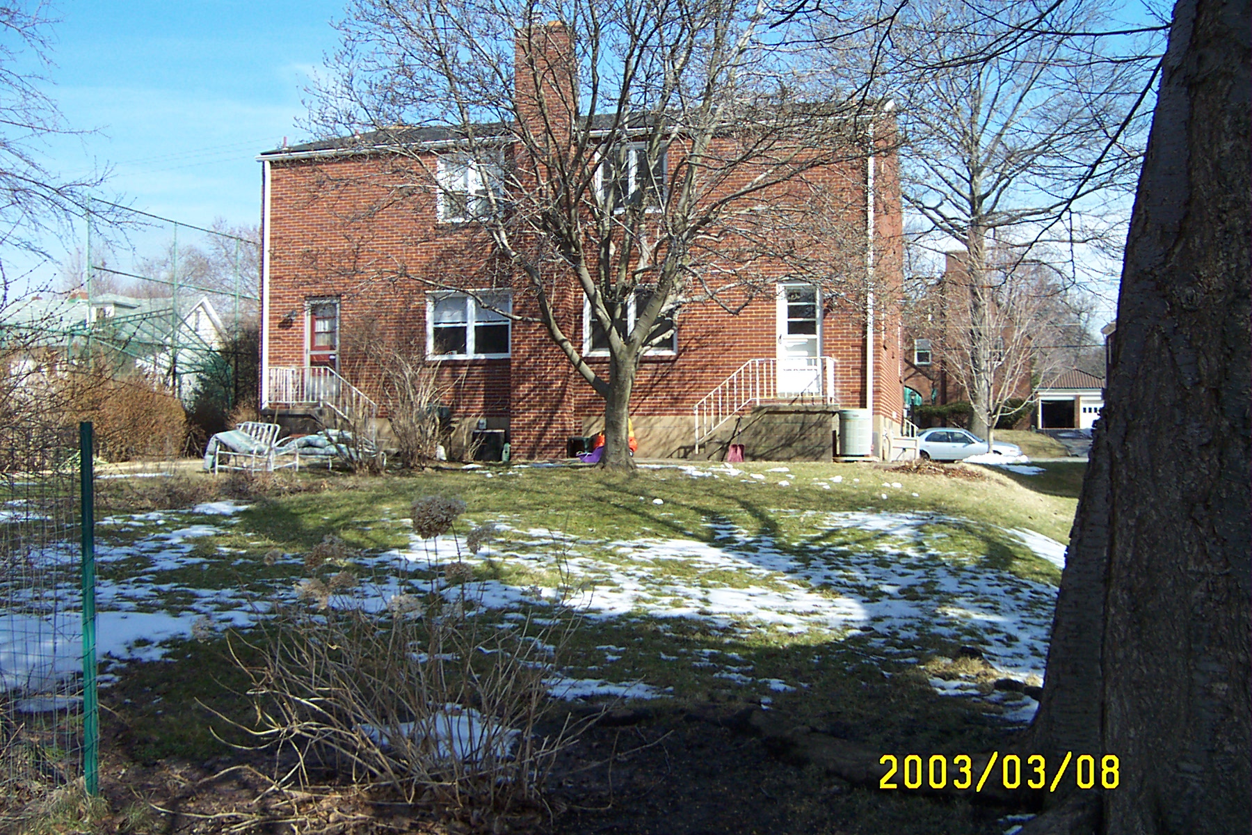 Back yard from the property line in the alley behind house.: 7140 Reynolds