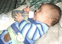 RFN2 doesn't want anybody bothering him when he's holding his bottle for the first time (LOOK AT THE FINGER!)