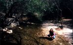 Lizzie gets down to nature (By pissing in a riverbed)