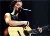 Sarah playing acoustic guitar live