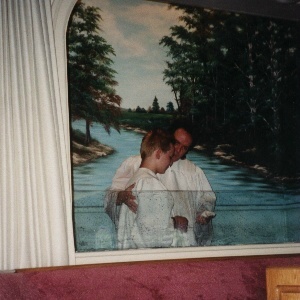 Derek being baptised by Pastor Bobby Baldwin