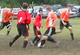 Brad tackles the ball while Geoff waits