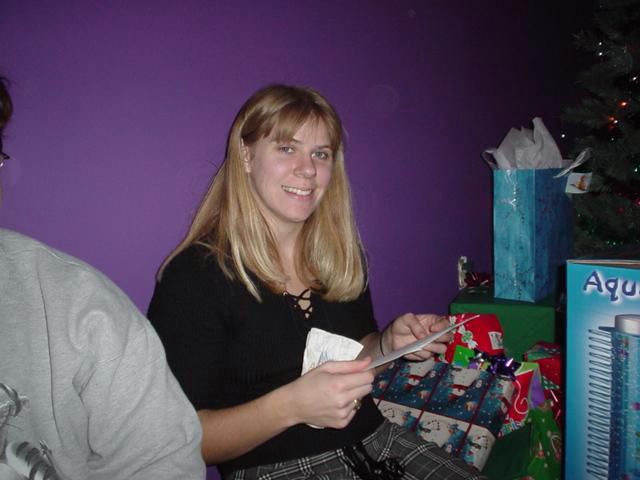Tanya looks like she is having fun opening gifts.