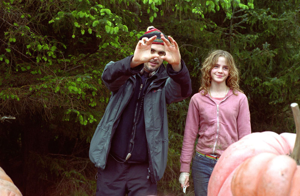 Director Alfonso Cauron shows something to Emma. Scene: The pumpkin patch behind Hagrid's hut