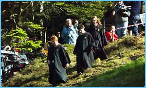 Harry, Ron and Hermione going down the hill with movie crew at the back :P