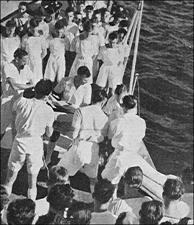 The crew of H.M.S London bury their dead.