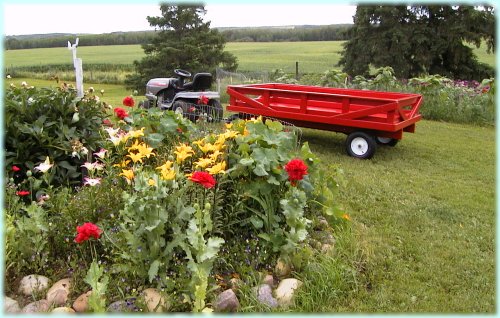 Red wagon in front of flower bed