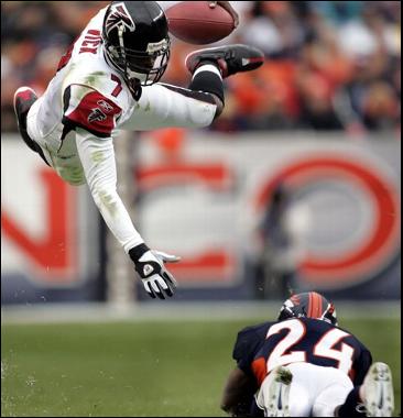 Micheal Vick flying over Champ Bailey