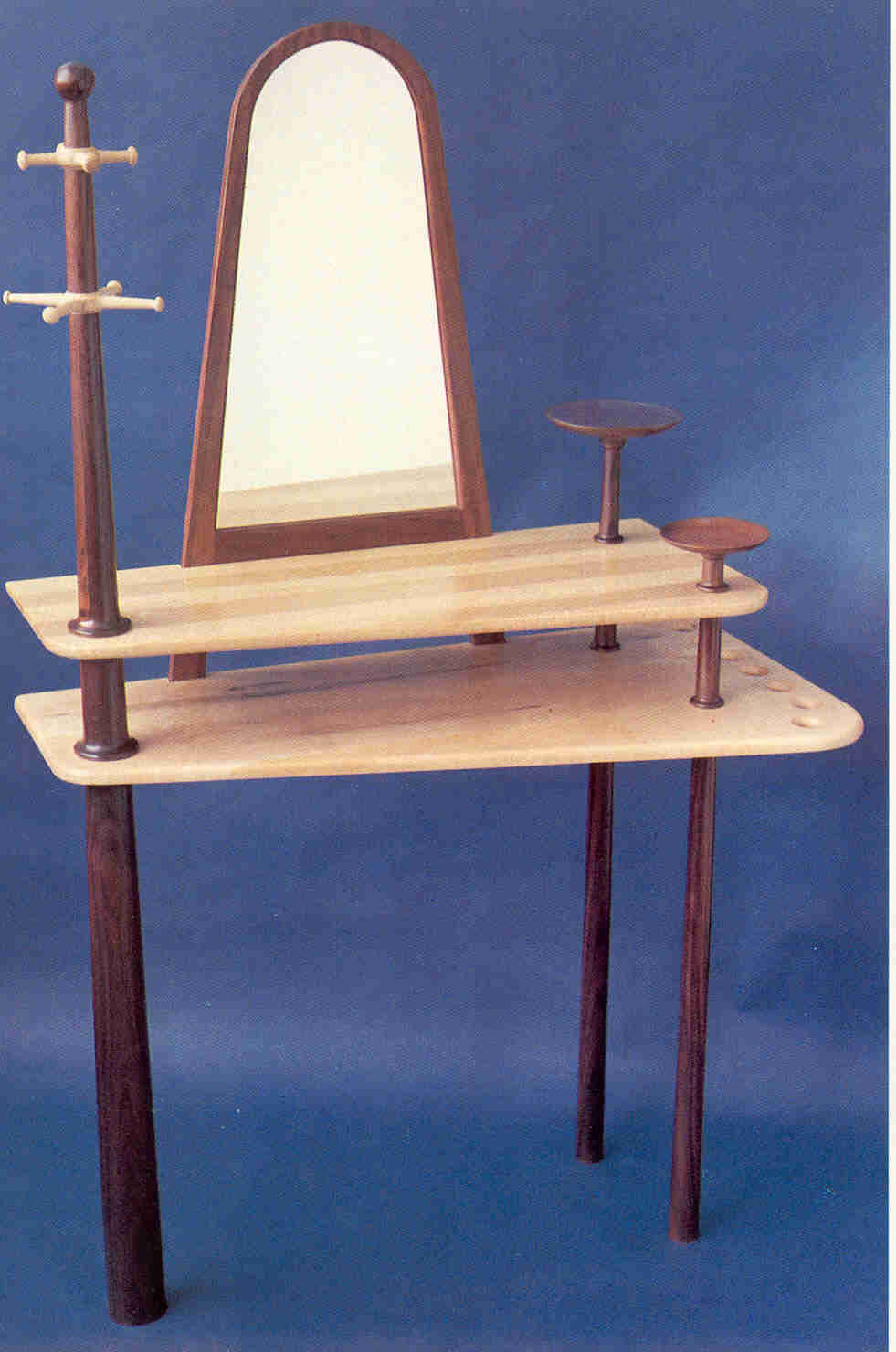 Entrance Ensemble, African padauk and bird's eye maple, 44"L x 24"W x 72"H, coattree and umbrella/walking stick rack on either end, mirror and shelves in middle.