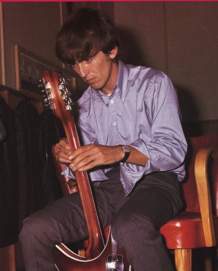 George examines his Rickenbacker