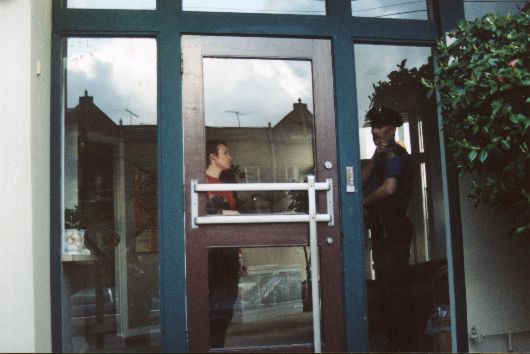 romalee_doc_service_with_cop_at_building_door_2001_04_07_530x354.jpg (31875 bytes)