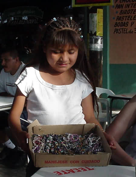 Girl selling bracelets in the plaza