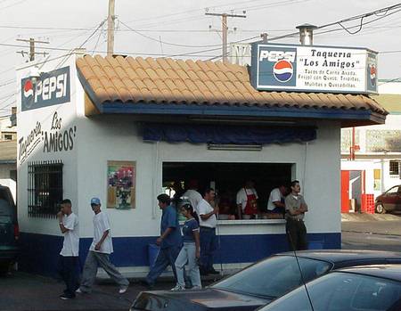 Taqueria at busy corner near the plaza