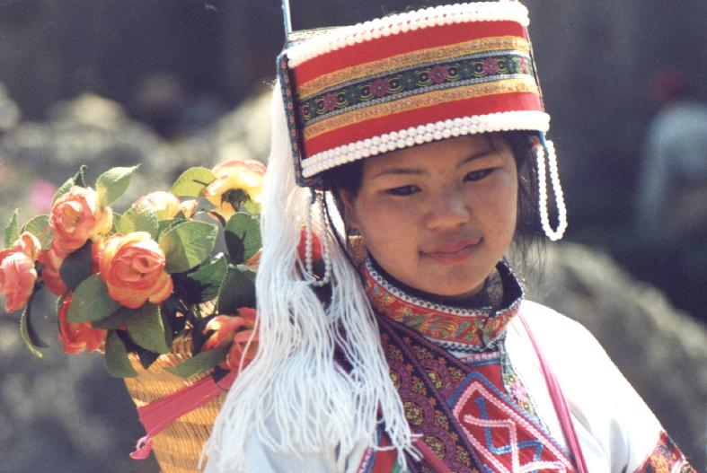 Beautiful poses from Chinese flower girl at Shilin Stone Forest near Kunming China