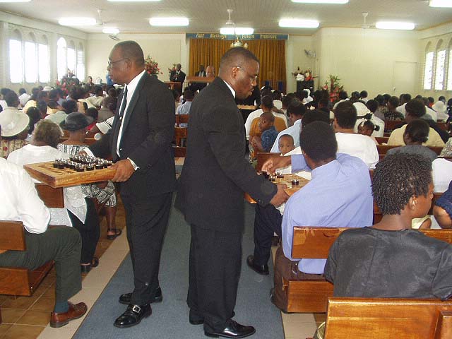 Deacons serving the congregation the wine.