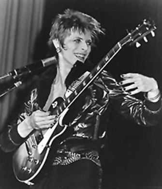 Bowie plays guitar