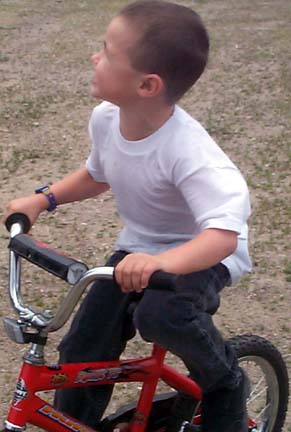 On his bike, learning earnestly.