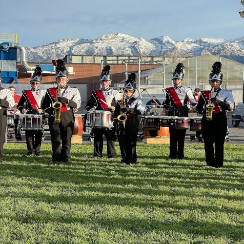Marching band members on field