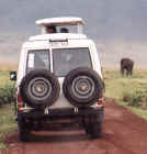 Land Rover awaits the oncoming bull elephant in the Crater