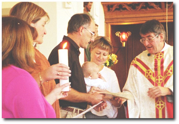 BAPTISED: Karen and Yvonne becoming godmothers. Father Jim presiding