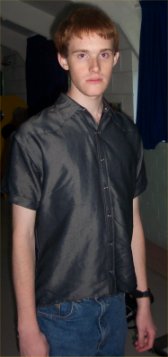 It is apparently a part of the Klingon Code of Honour to wear a shiny silver shirt
