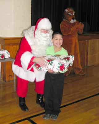 Santa delivers a present to another happy child.