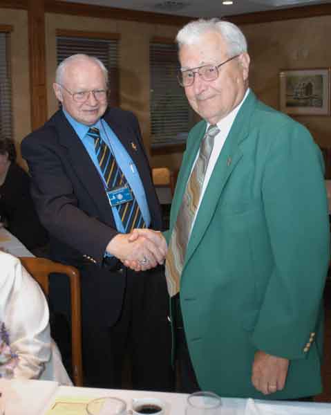 Club Secretary Lion Wil Hufton (left) presents 100 Percent Attendance awards to members, including, Lion Bob Kretchman.