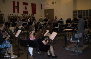 We warm-up in the orchestra room; note the flags, they toured Germany, Canada, and China (wow).