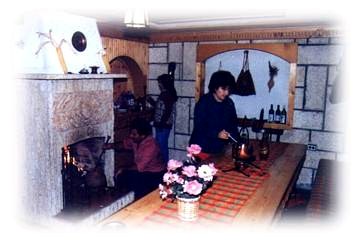 My father is working on the fire and my mother and sister are doing the cooking