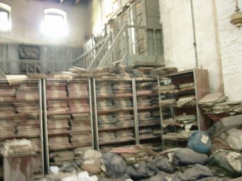 Priceless paper record from 19th century littered on the floor and in stacks