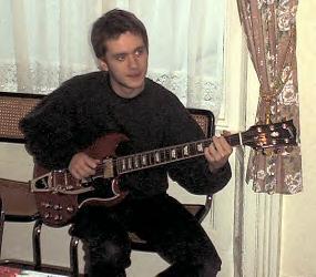 Sean playing his guitar.