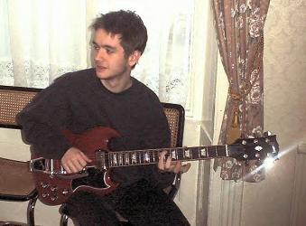 Sean playing his guitar.