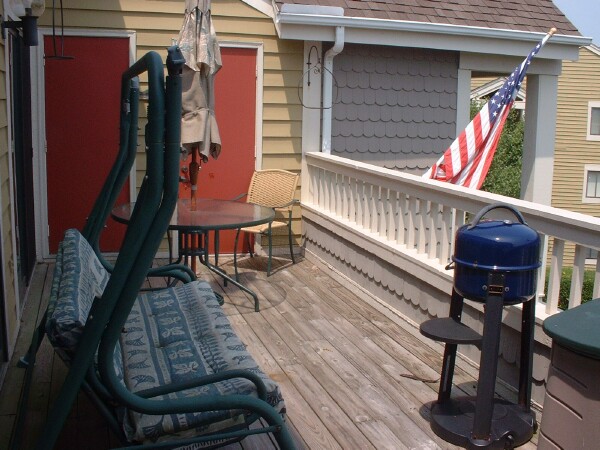 Large Deck with Table, Glider, and BBQ Grill included