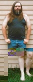 Scruffy Songdog, cutoffs, t-shirt, and barefoot, thumbnail