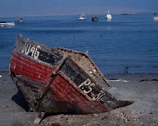 Photo of a broken boat by a shore