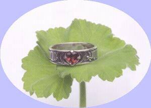 Pour Amor Say Douc, For Love so Sweet, French Poesy Betrothal Ring, shown in sterling silver with heart shaped garnet