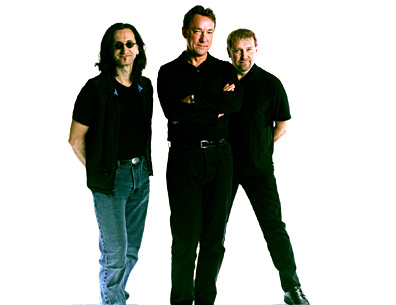 Rush (from left to right): Geddy Lee (Bass, Vocals, Synthesizers), Neal Peart (Drums and Percussion), Alex Lifeson (Guitars)