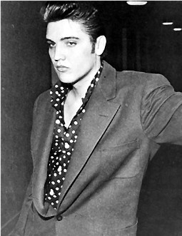 Elvis standing in a hallway.