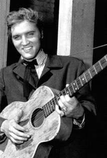 A 1950s Elvis with his guitar on the set of Love Me Tender
