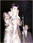 Elvis wearing gold suit.