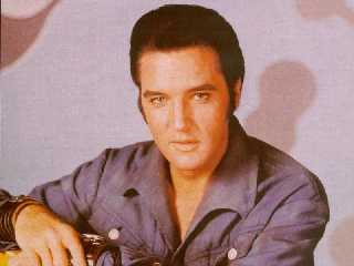 Elvis in the late 1960s with his guitar.
