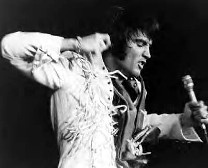 Elvis in the 1970s wearing a fringe jumpsuit.