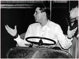 Elvis behind the wheel of a go-cart.