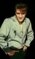A young Elvis wearing a green jacket.