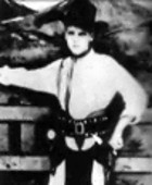 Elvis as a little boy dressed up like a cowboy.