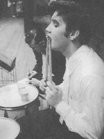 Elvis being silly with the drumsticks.