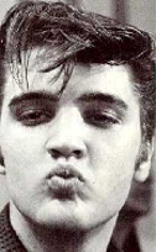 A young Elvis blows a kiss to the camera.