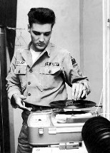 Elvis taking time out to listen to a record while in Army.