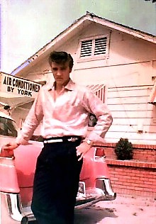 Elvis standing by his Pink Cadillac.