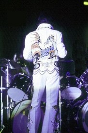 Elvis onstage facing band.